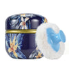 A dark blue refillable loose powder container with a gold band and a fluffy light blue travel puff.