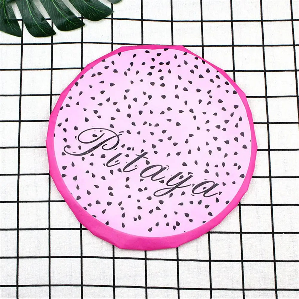 Pink fruit-design waterproof shower cap with a black speckled pattern on a white checkered background
