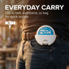 A white car sun visor can holder with a clip is shown being carried in a front pocket of dark jeans.