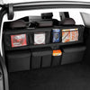 Interior view of a car showing a black foldable trunk organizer with seat back storage compartments.