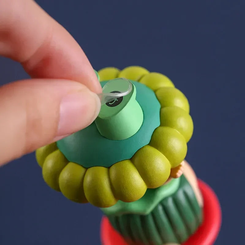A hand is peeling off a clear adhesive patch from a green and yellow product component.