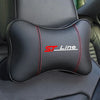 Black ergonomic car neck pillow with red stitching and ST Line logo placed on a dark car seat.