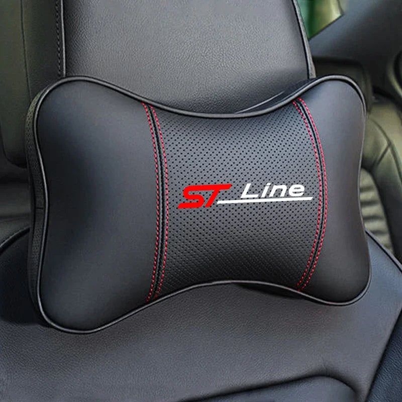 Black ergonomic car neck pillow with red stitching and ST Line logo placed on a dark car seat.