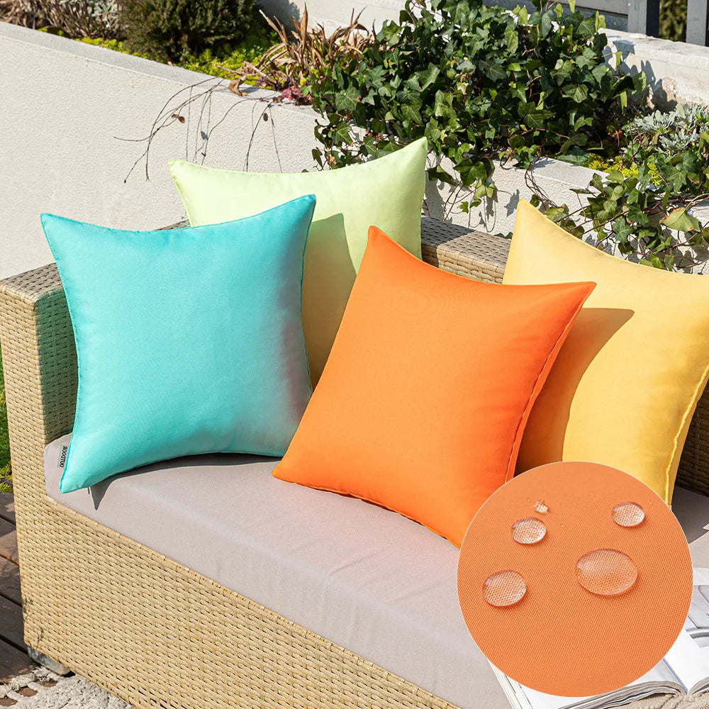 A collection of colorful linen-textured outdoor pillow covers in shades of turquoise, lime green, orange, and yellow displaye