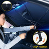 A hand is operating a foldable car windshield sun shade umbrella with an emergency hammer for 360 degree rotation.