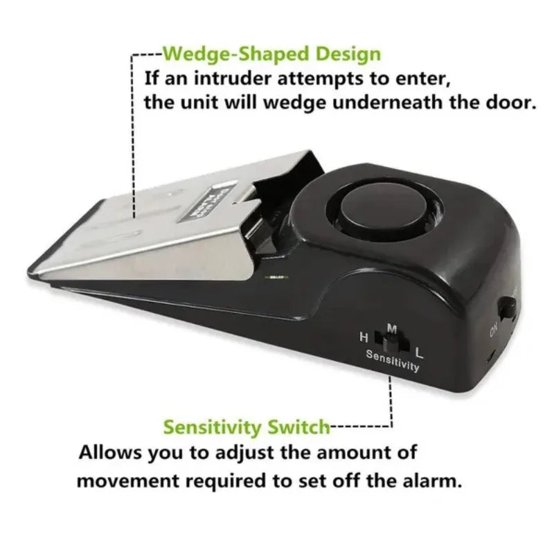 A black wedge-shaped door stop alarm unit with a sensitivity switch and a wedge design.