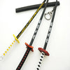 A replica Demon Slayer mini katana sword with a black handle, yellow hilt, and white blade, displayed against a white backgro