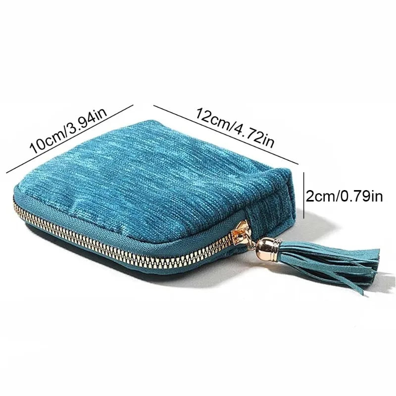 Teal velvet jewelry organizer bag with a gold-toned tassel zipper and measurements.