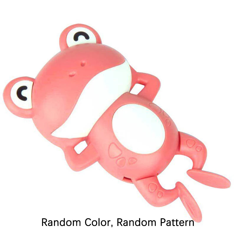 A pink wind-up swimming frog bath toy with a white belly and round features.