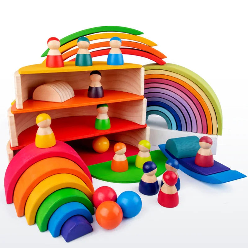 A set of wooden rainbow stacking blocks and figures used for creative building and Montessori activities.