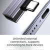 Close-up view of a silver USB-C to 3.5mm audio adapter with charging support plugged into a device.
