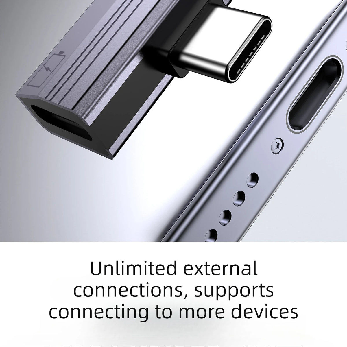 Close-up view of a silver USB-C to 3.5mm audio adapter with charging support plugged into a device.