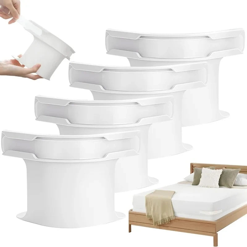 A set of white bed sheet corner grippers and straps are shown being used to secure bedding on a bed.