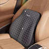 A black memory foam car headrest and lumbar support cushion placed in a tan leather car seat.