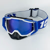 Blue and white motorcycle goggles with a black strap and lens resting on a white background.