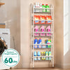 A white multi-tier storage rack with shelves holding various cleaning products and household items.