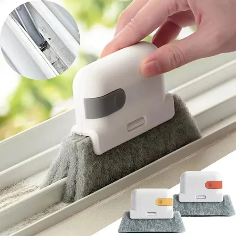 A hand is using a white multi-purpose crevice cleaning brush to clean window tracks and tight spaces.
