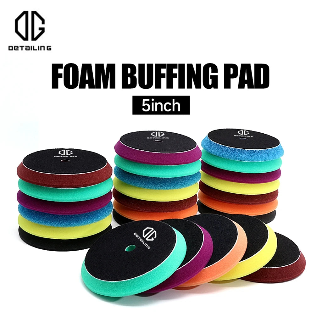 A stack of various foam buffing pads in different colors including black, green, yellow, purple, and orange.