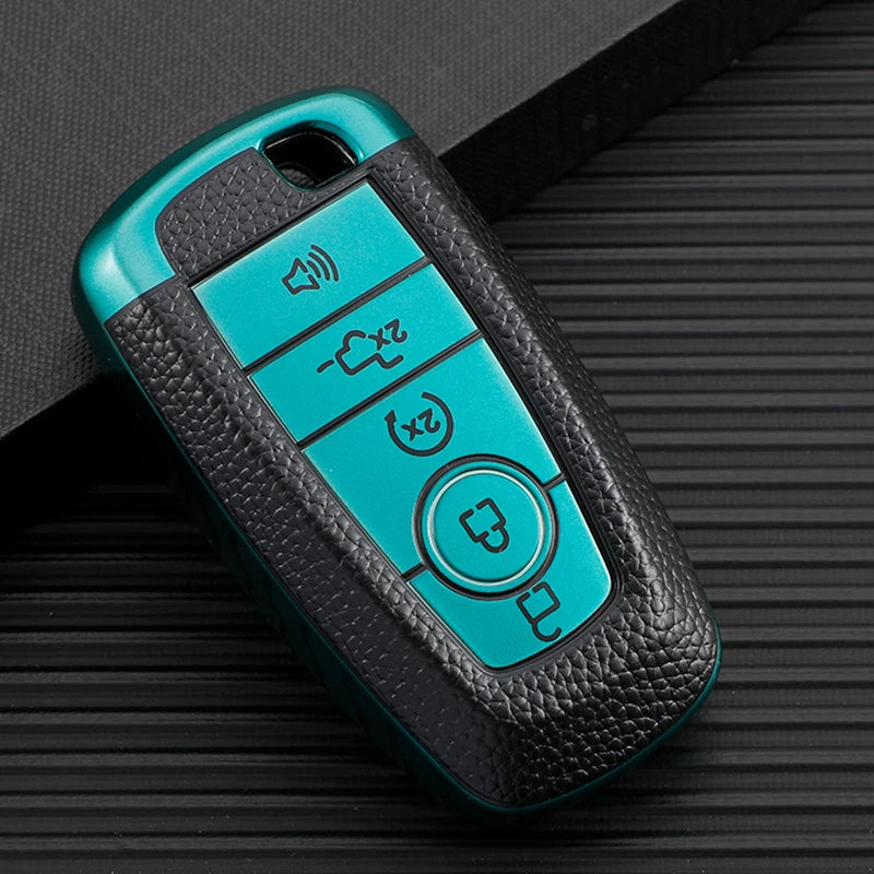 A teal TPU leather car key cover with multiple buttons rests on a dark textured surface.