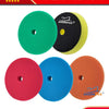 A set of four colored car care polishing sponge pads for professional car care.
