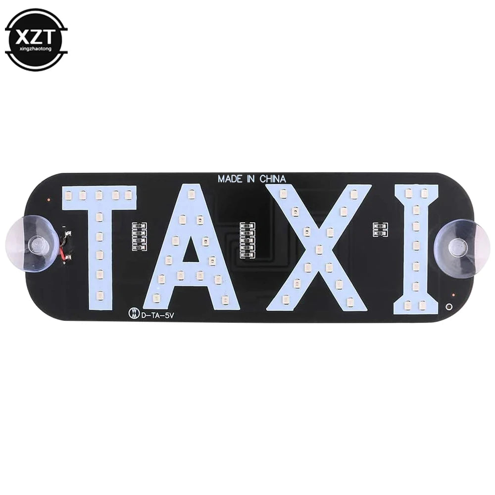 Black LED taxi indicator light panel with the word TAXI illuminated on it