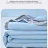 Light blue cooling quilt folded neatly, showing its breathable fabric and layers.