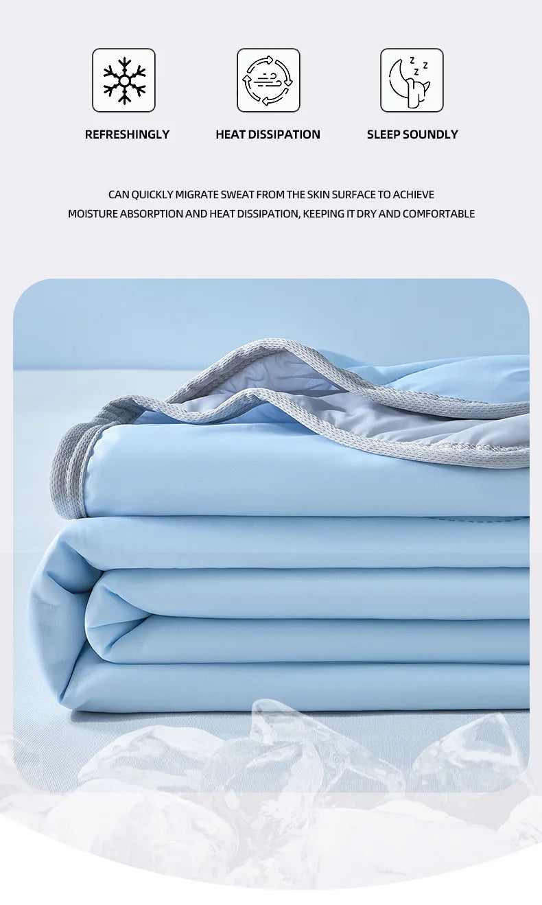 Light blue cooling quilt folded neatly, showing its breathable fabric and layers.