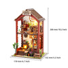 A wooden magic shack diorama kit featuring a detailed interior with LED lighting and rustic decor.