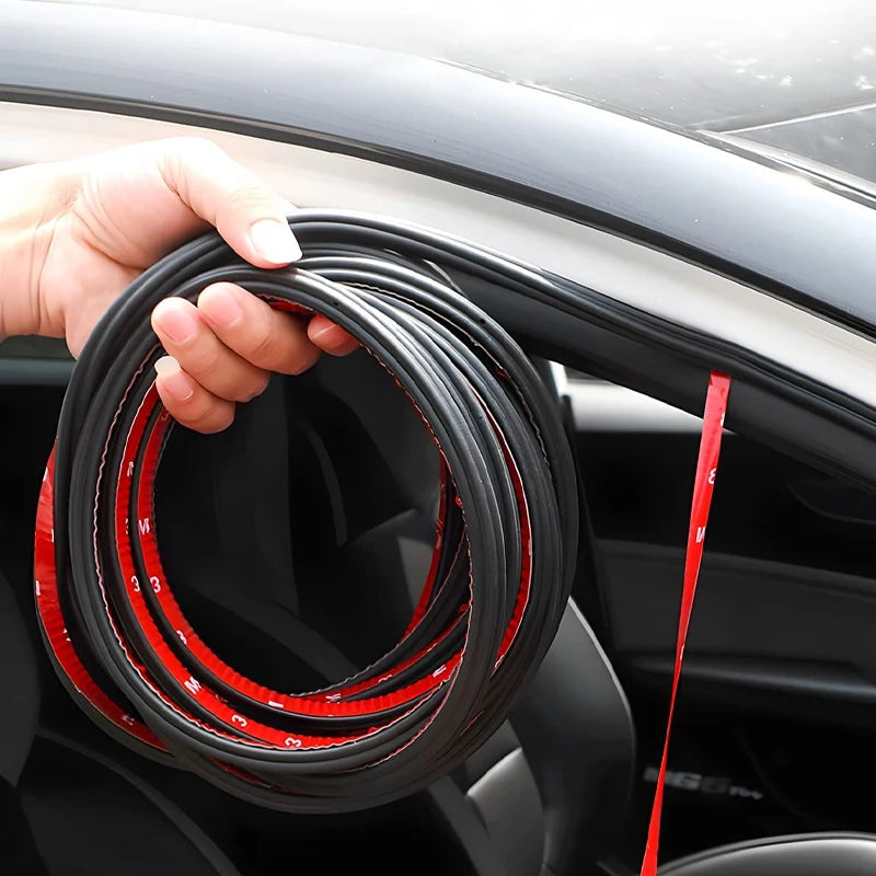 Une main tient une bobine de joints pour portes de voiture rouge et noire pour l'isolation phonique.
