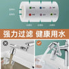 A rotating faucet extender with dual spray heads is shown next to a glass of water.