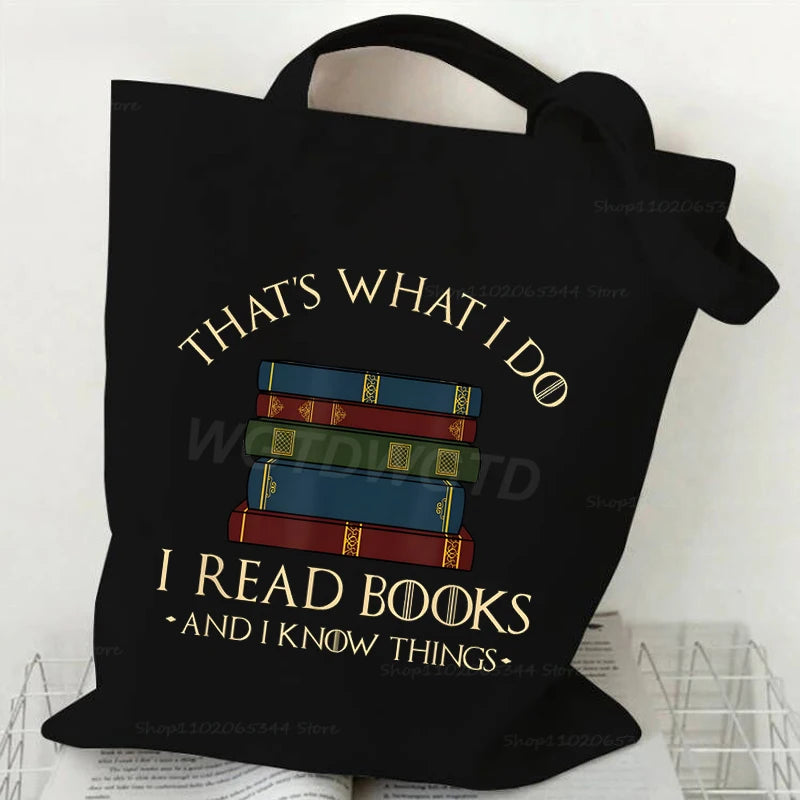 Black canvas tote bag featuring text that says That's what I do I read books and I know things