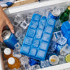 Blue gel ice blocks stacked in a clear ice cube tray inside a cooler with various bottles and ice.
