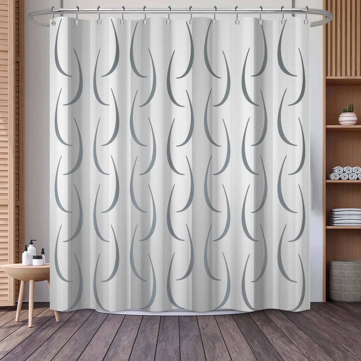 A white shower curtain featuring a gray geometric stripe pattern hanging from a metal rod.