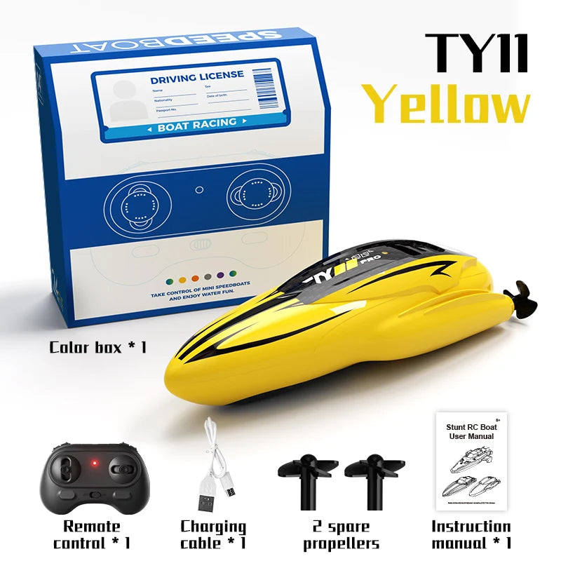 Yellow TY11 racing speedboat kit including a driving license box, remote control, propellers, and instruction manual.