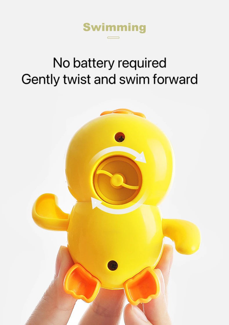 A yellow wind-up bath toy duck is held in a hand, ready for swimming.