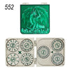A green metal dice set featuring a dragon design and a separate set of 7 metal dice.