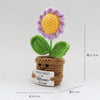 Handmade crochet flower plant decor featuring a purple and yellow bloom on a green stem and brown pot.