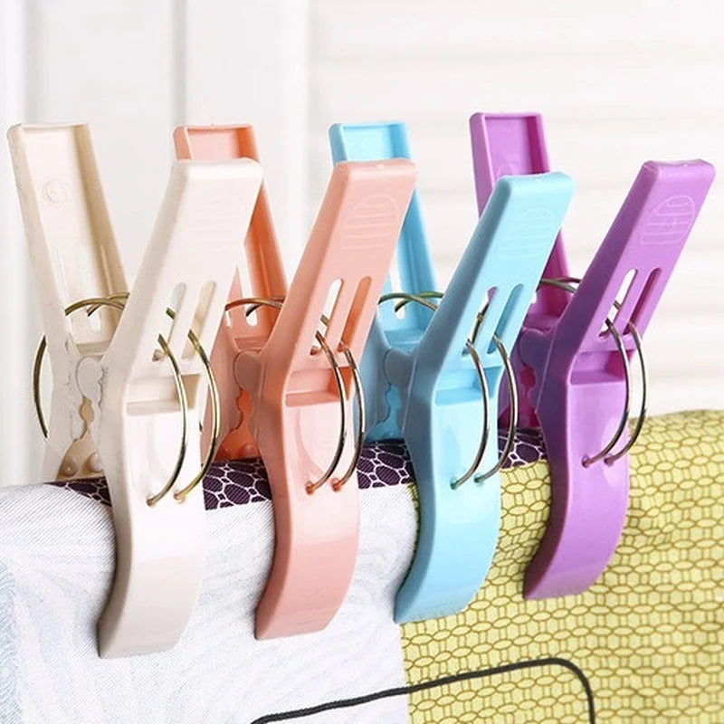 A collection of heavy-duty laundry clips in various colors including beige, pink, blue, and purple.