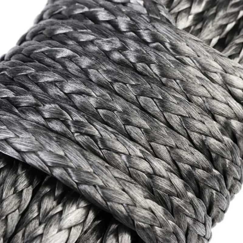 Close-up of a thick gray synthetic winch rope coiled and wrapped tightly.