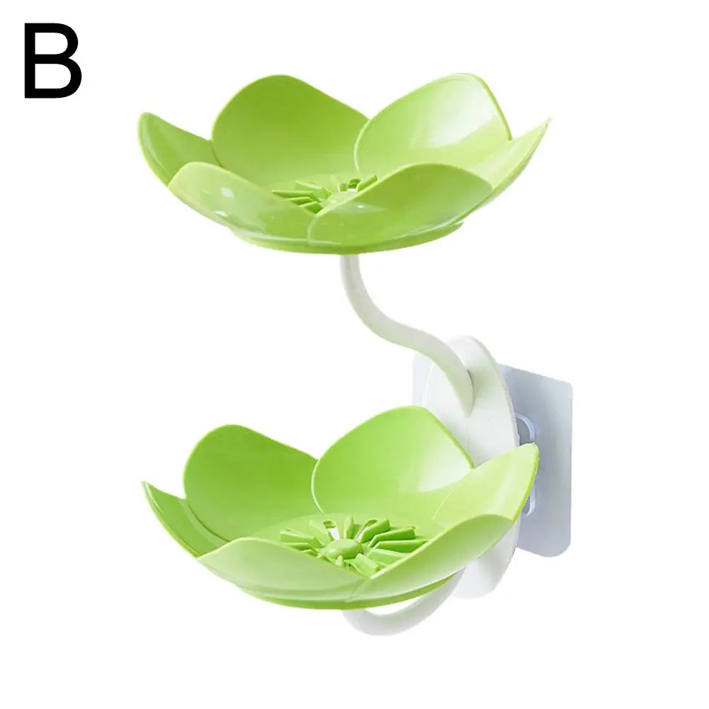 A green two-tier bathroom storage rack with lotus-shaped drainage features.