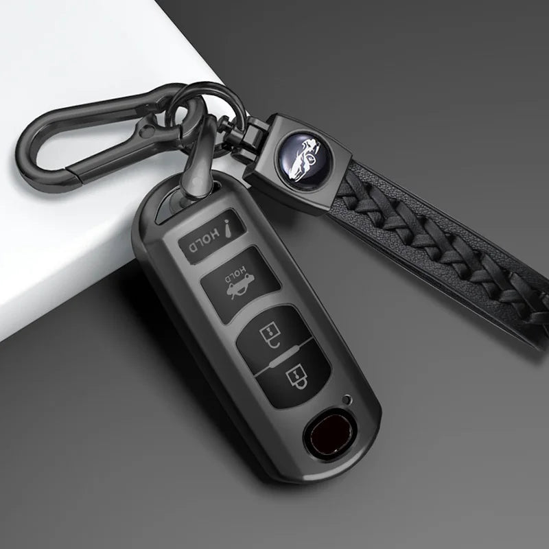 A close-up of a black TPU car key cover with a metal keyring and lanyard attached.