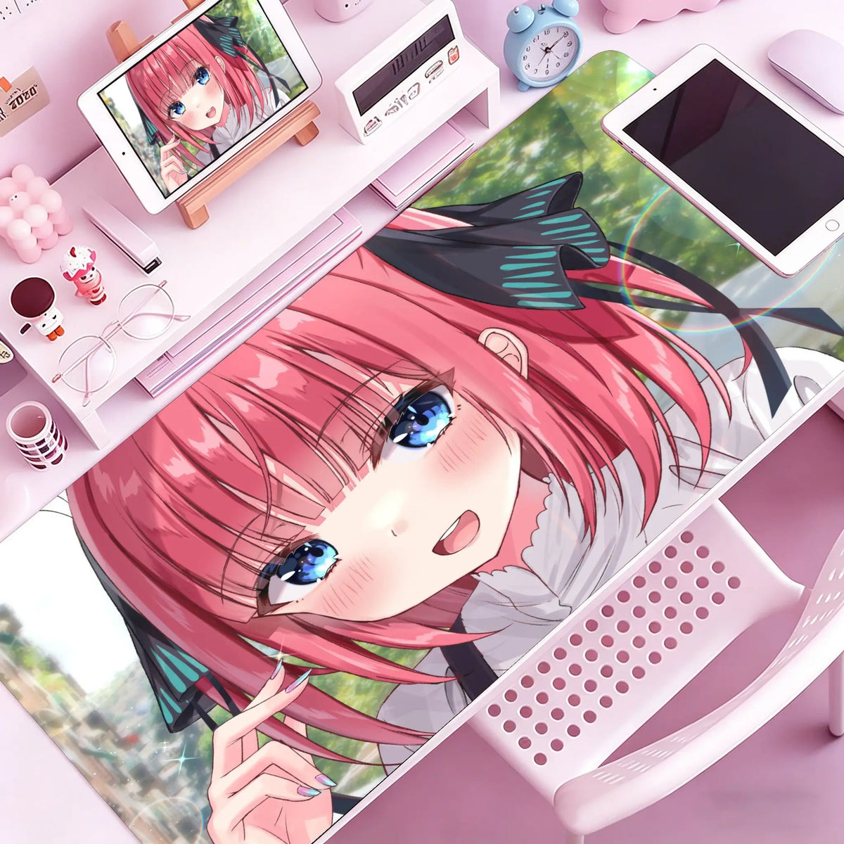 Anime character illustration of a girl with pink hair on a mouse pad or desk mat.