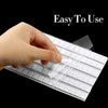 A hand is pressing a white, grid-patterned reusable nail glue clay onto a surface.