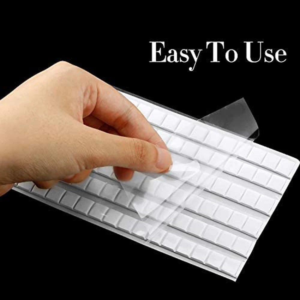 A hand is pressing a white, grid-patterned reusable nail glue clay onto a surface.