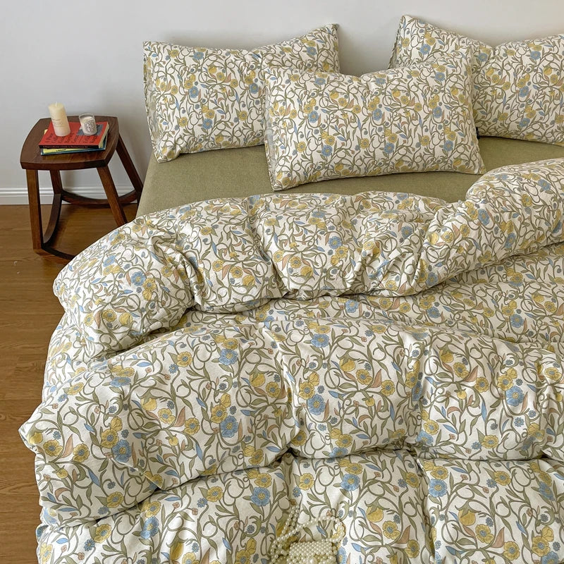 A beige printed duvet cover set featuring a floral pattern in yellow, blue, and green tones with matching pillowcases.