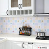 White kitchen cabinets and splashback featuring a light blue and beige patterned tile design.