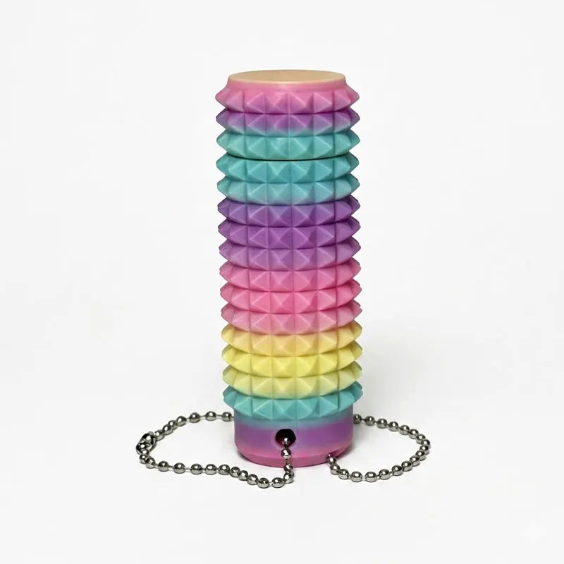 A stack of colorful, spiky fidget keychains in a rainbow gradient.
