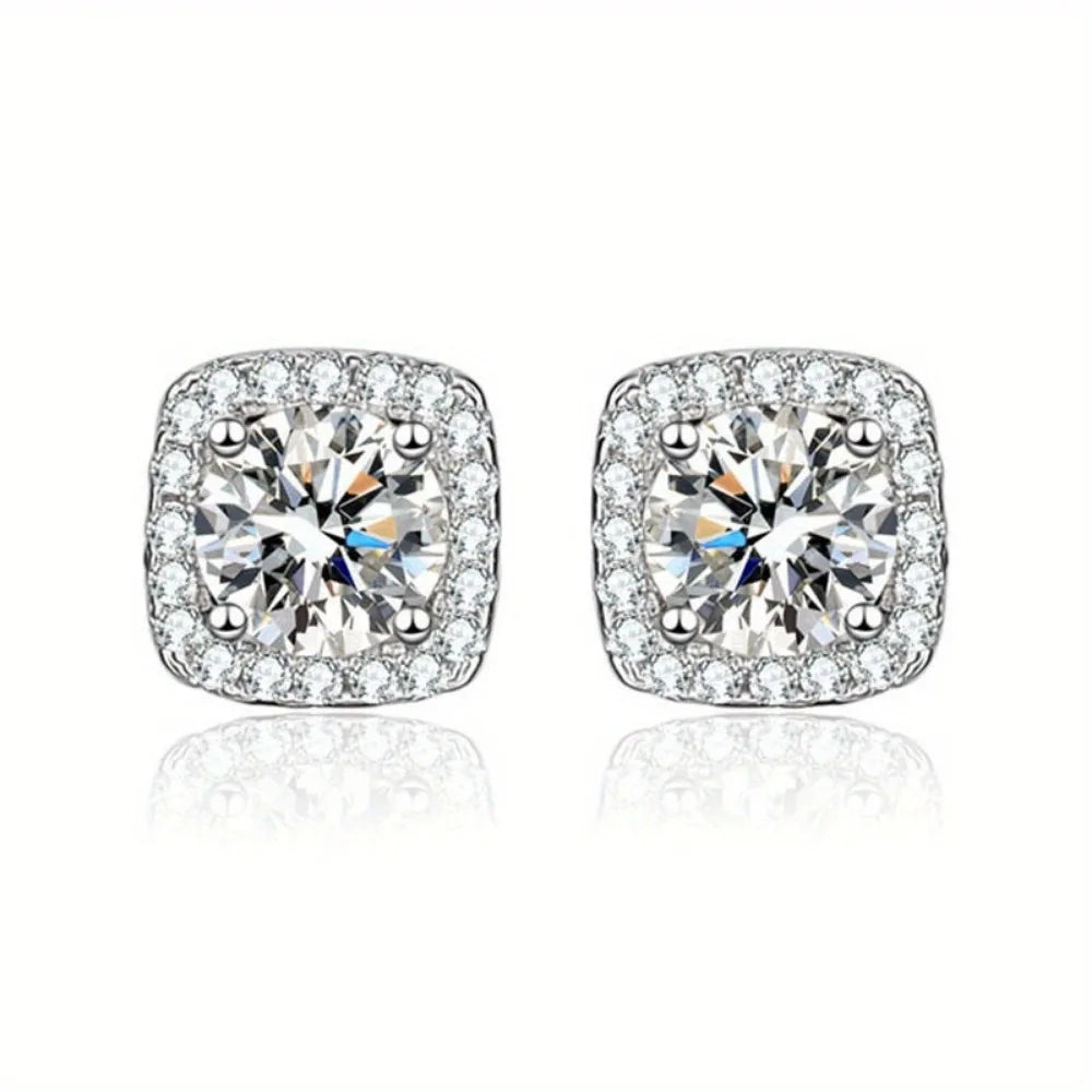 Pair of silver-tone cubic zirconia stud earrings with round brilliant stones.
