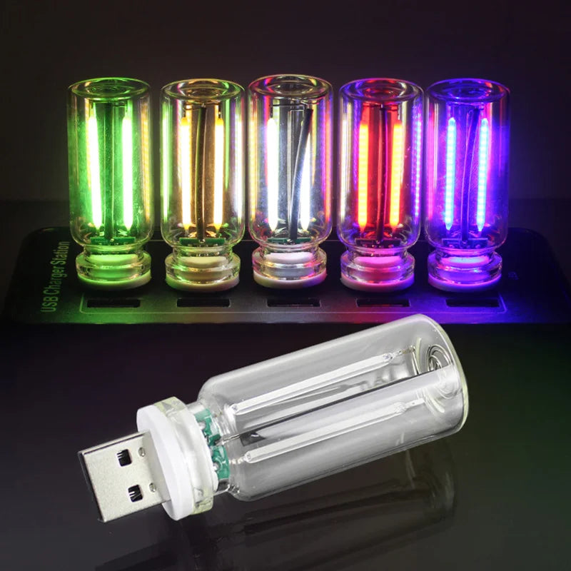 A row of ten glass tubes displaying various colors of LED light, including green, yellow, red, and purple.
