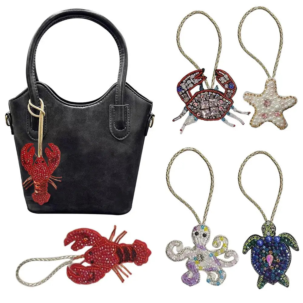 Handcrafted rhinestone bag charms featuring a sequin octopus and turtle pendant keychains.
